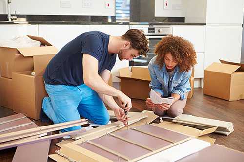 Couple putting furniture together