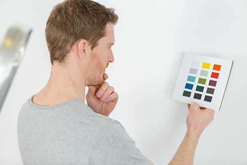 Man looking at paint colors